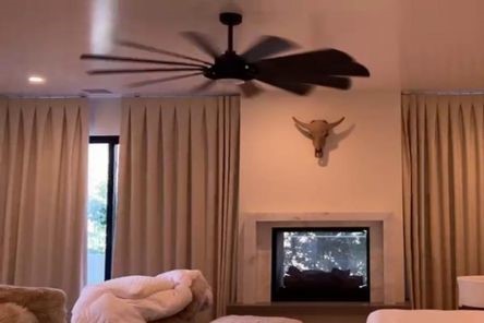 Somfy electric blackout curtain in action, smoothly gliding across the window in a modern Tustin master bedroom.
